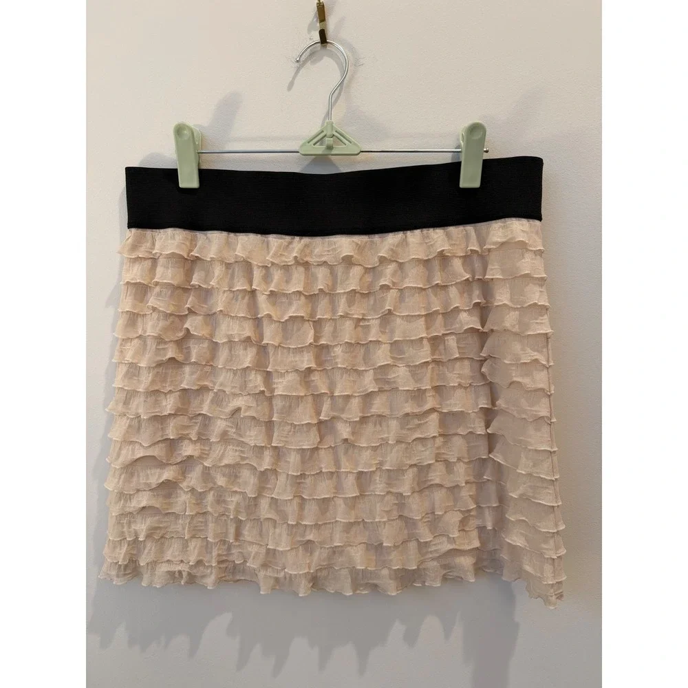 Medium Free People beige ruffle mini skirt thick black elastic waistband.